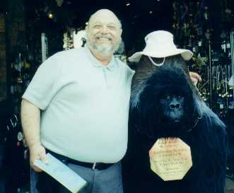 David poses with a very large stuffed toy gorilla